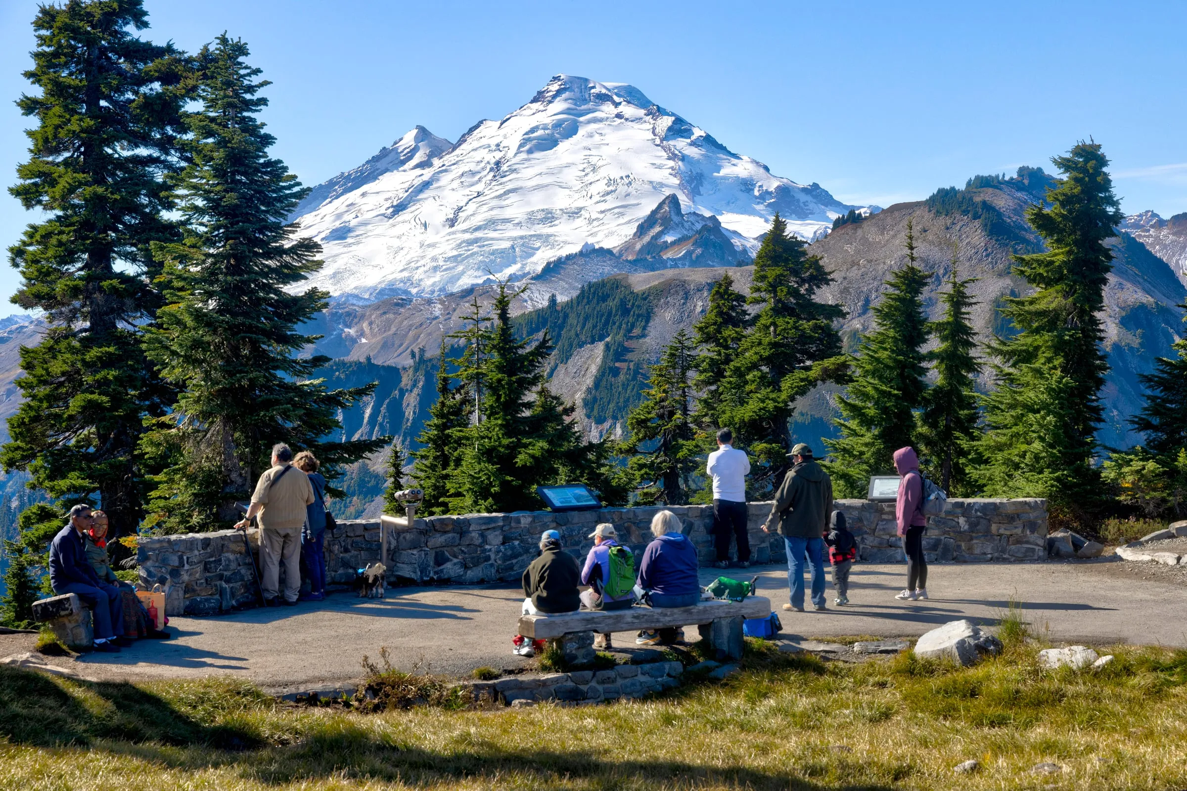 Visitors at the stone overlook at the end of the Mt. Baker Highway looking at Mount Baker in October