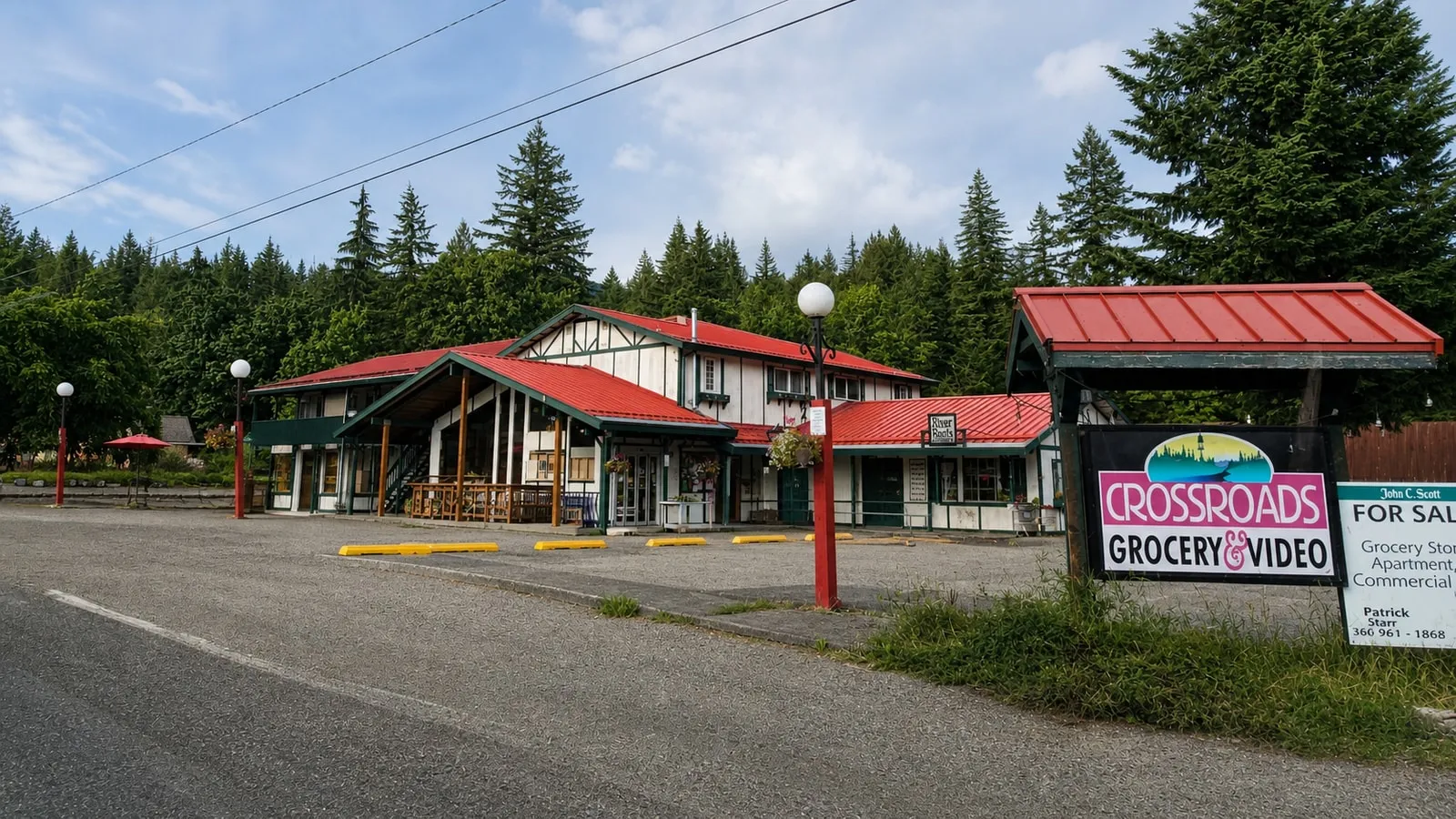 Crossroads Grocery’s red-roofed storefront and roadside sign on Silver Lake Road in Maple Falls