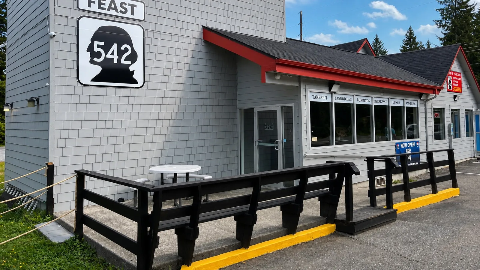 Feast 542’s gray storefront and outdoor tables at Paradise Market on the Mt. Baker Highway
