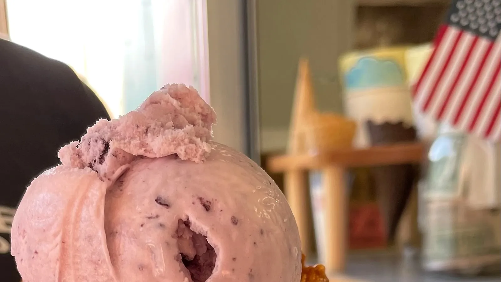 A waffle cone with strawberry and huckleberry ice cream from Glacier Ice Cream Company