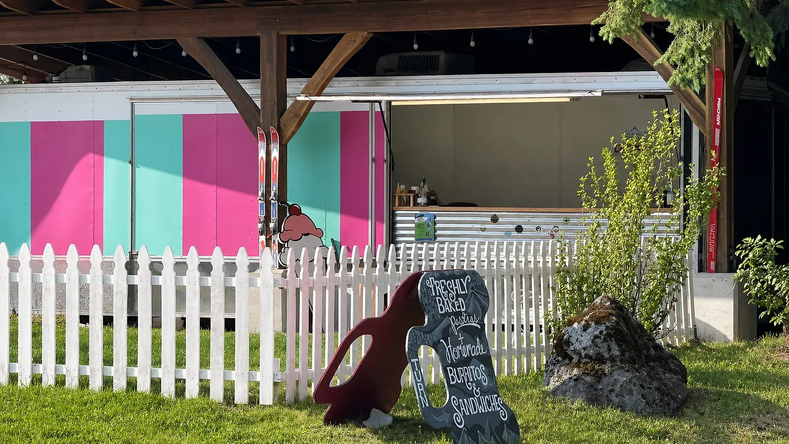 The pink and turquoise Glacier Ice Cream trailer and open service window in Glacier, Washington