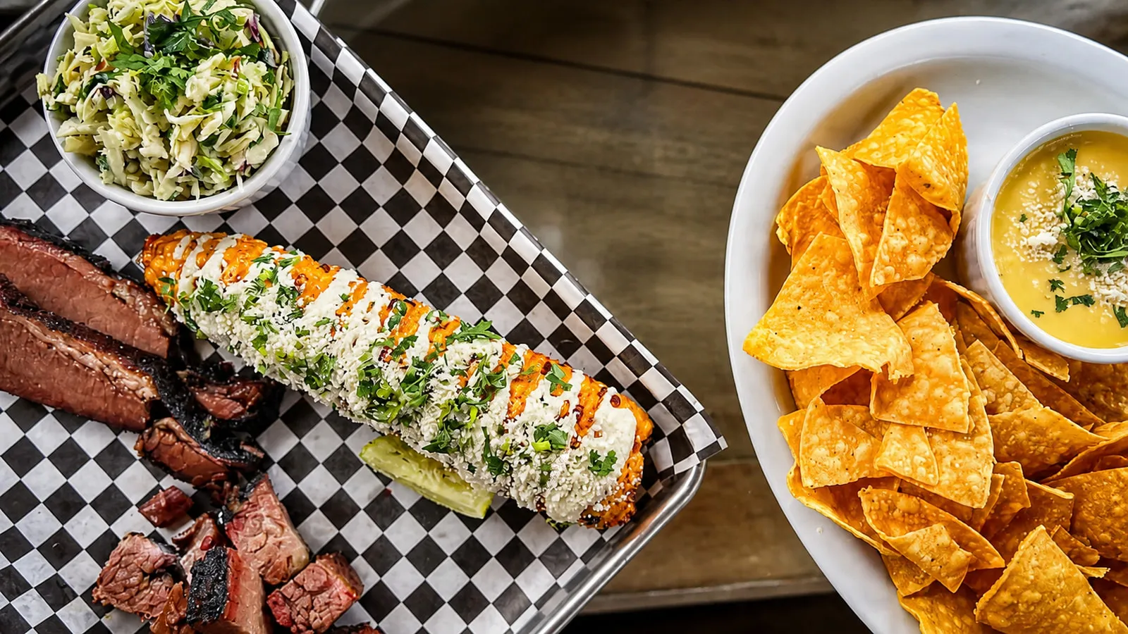 Smoked brisket, elote, slaw, chips and queso served at Gunners Tex Mex BBQ