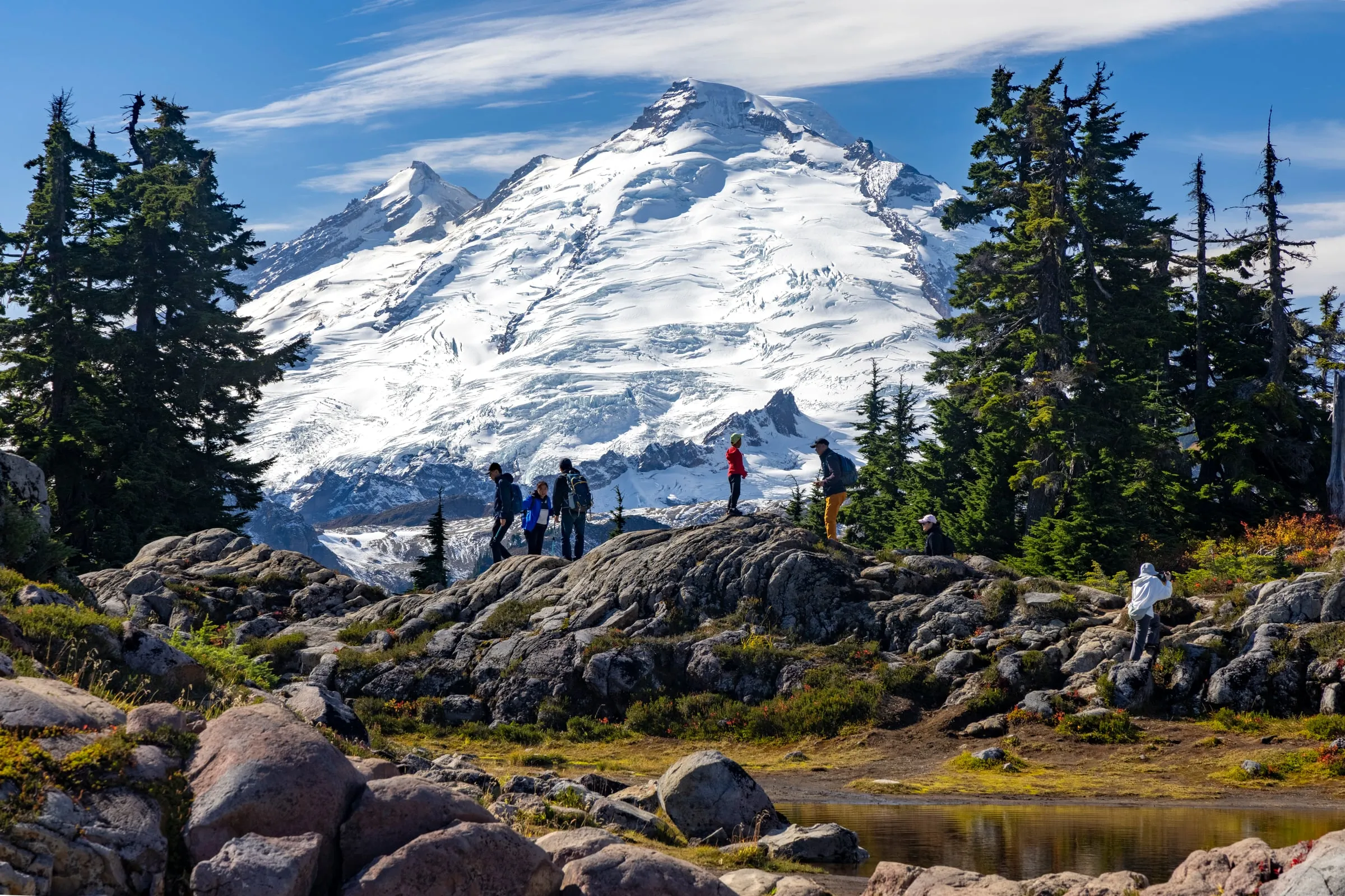 Alpine tarns and rocky knolls in the Bagley Lakes basin at Heather Meadows with Mount Baker beyond