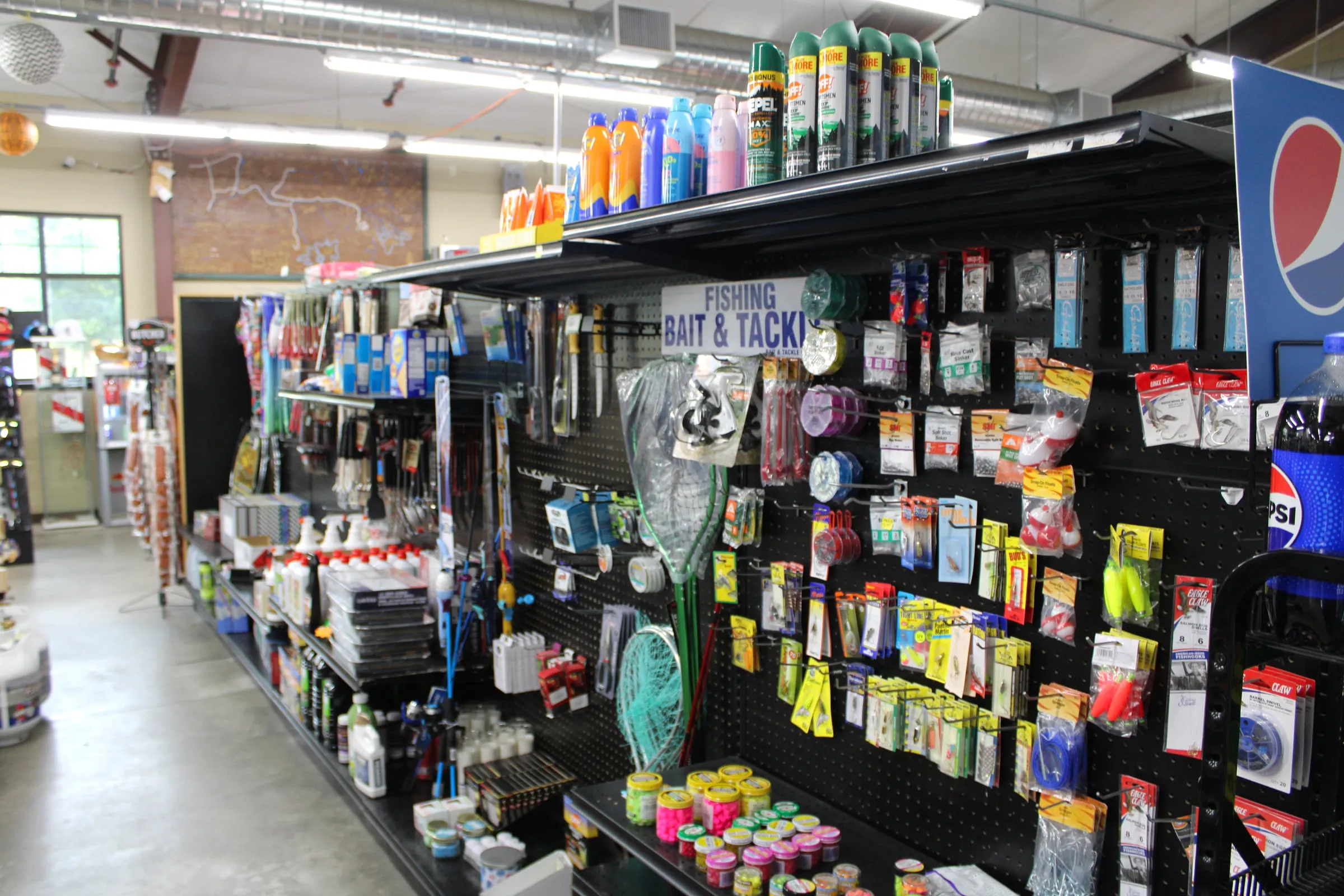 The fishing bait and tackle aisle inside the Maple Fuels store