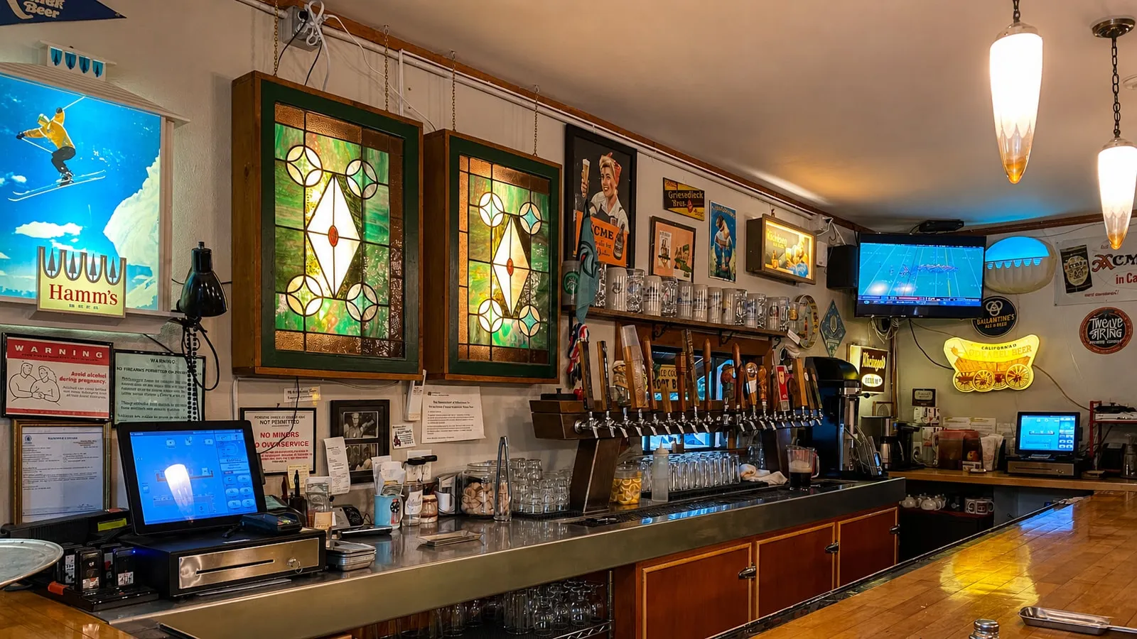 The stained-glass windows, beer taps and vintage signs inside North Fork Brewery’s bar