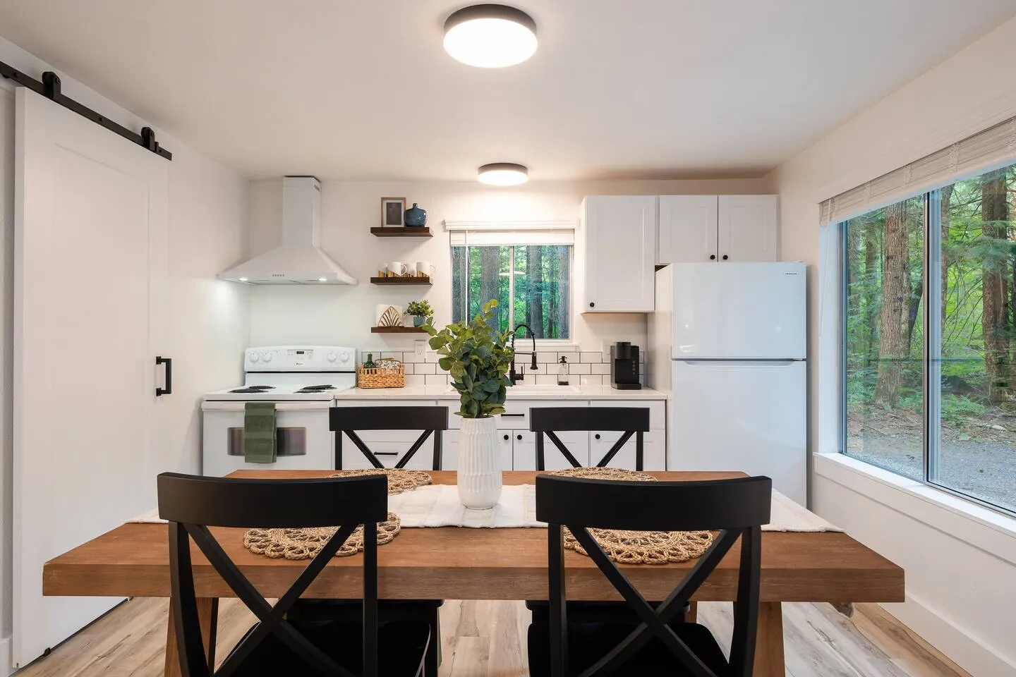 Kitchen with dining table and forest views
