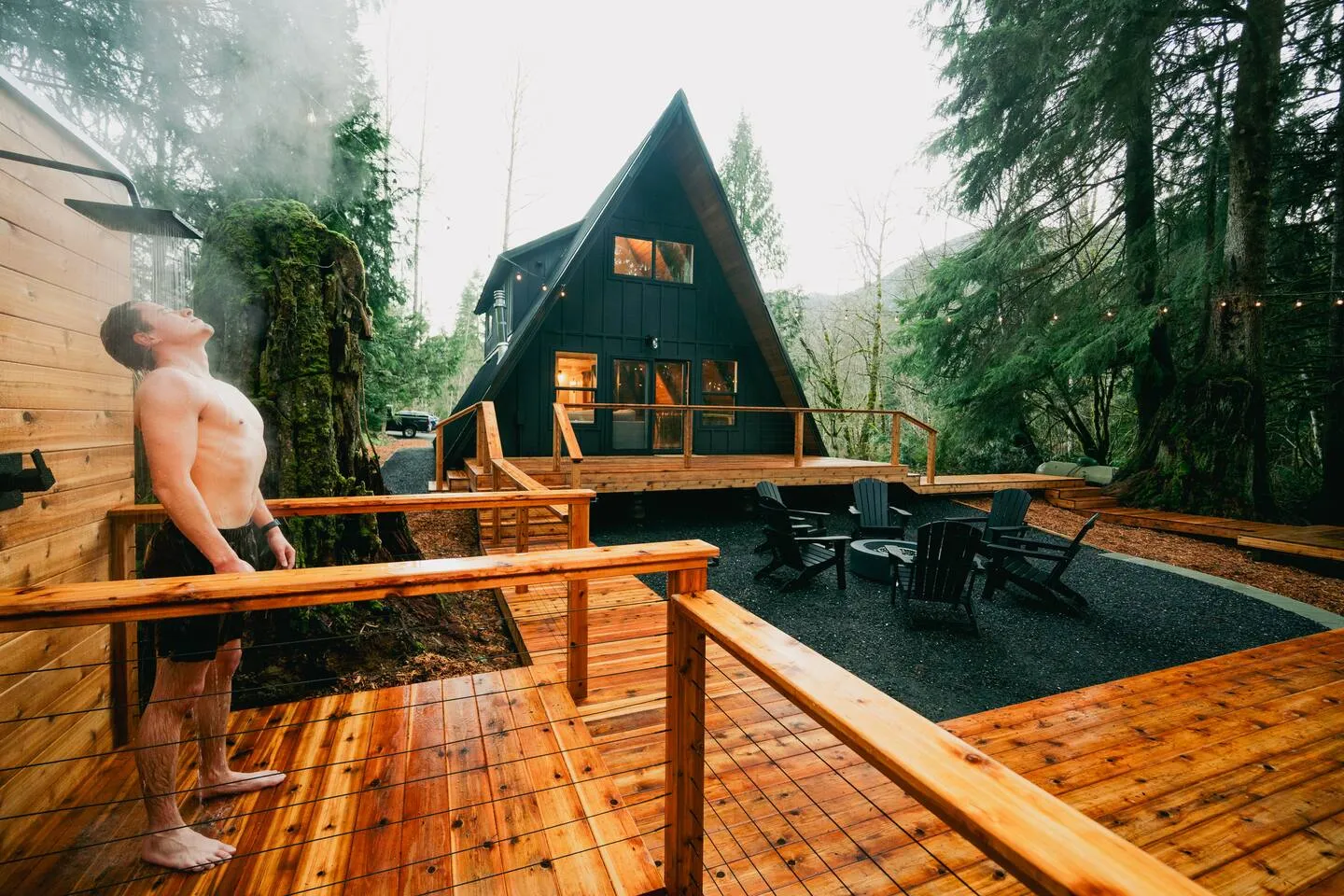 Wraparound cedar deck at the black A-frame cabin