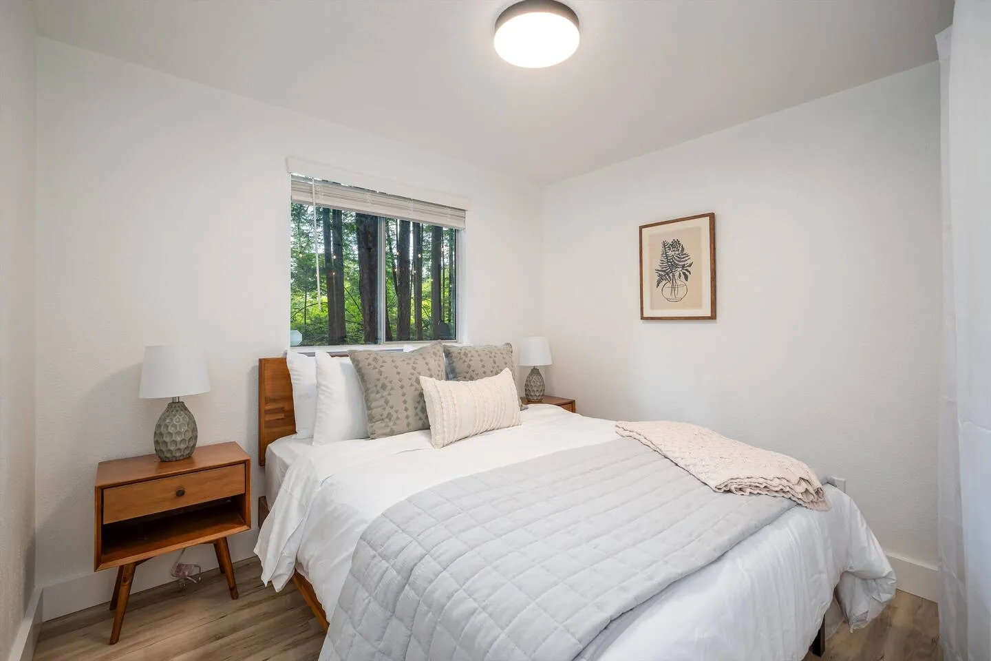 Bedroom 2 with queen bed and soft white linens