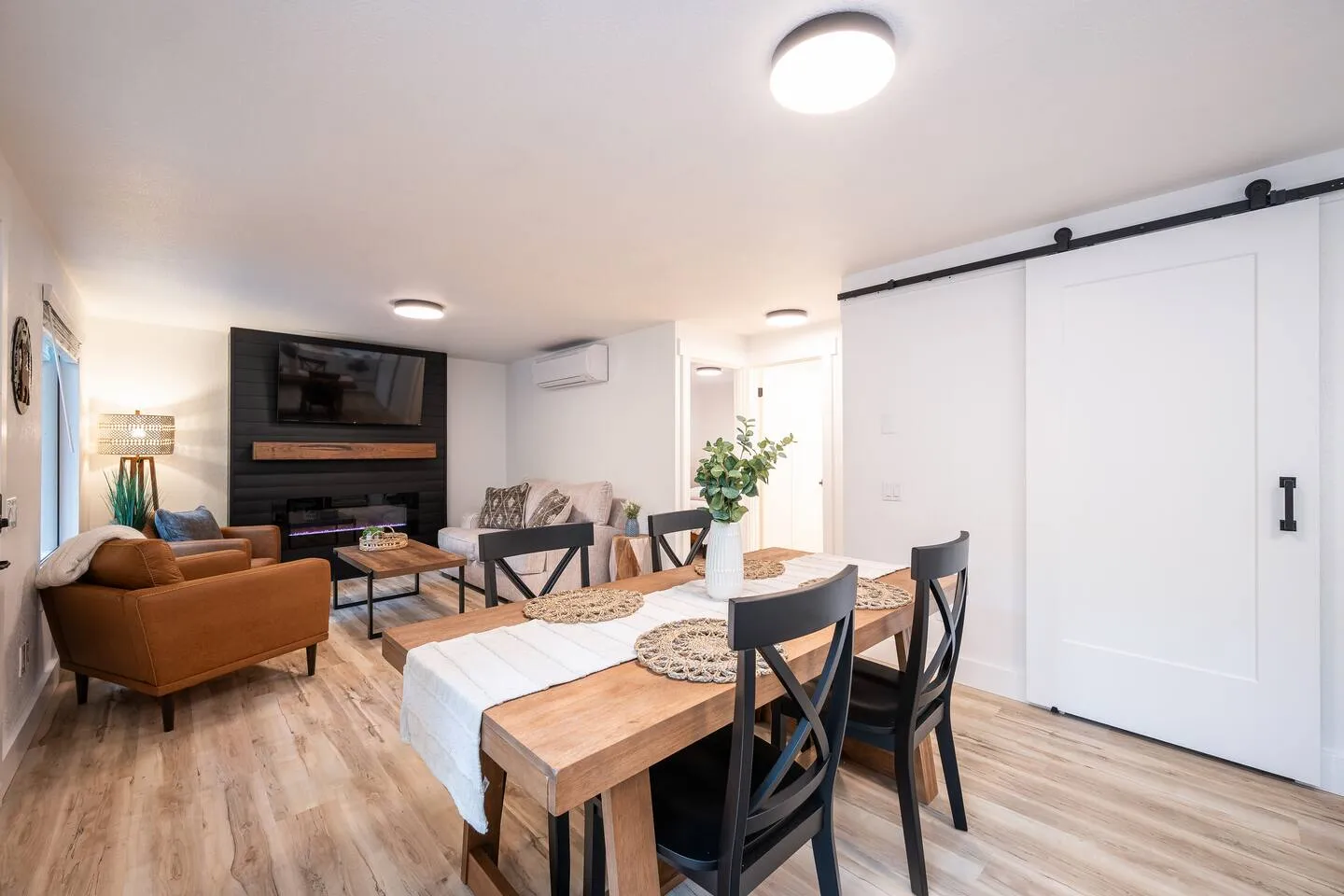 Living and dining area with sliding barn door