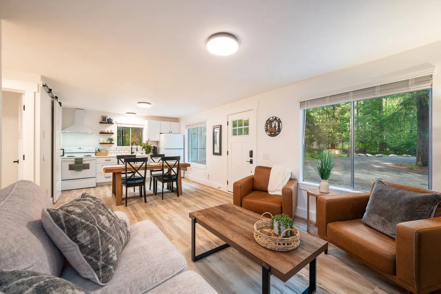 Open living area with leather chairs and mounted TV