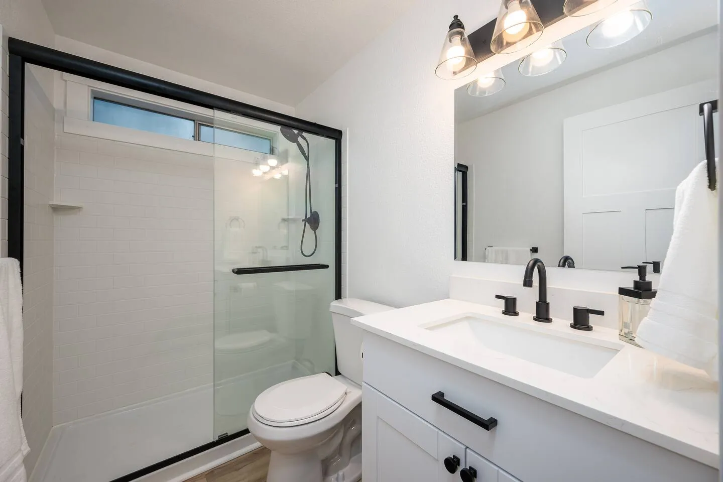 Bathroom with walk-in shower and black fixtures