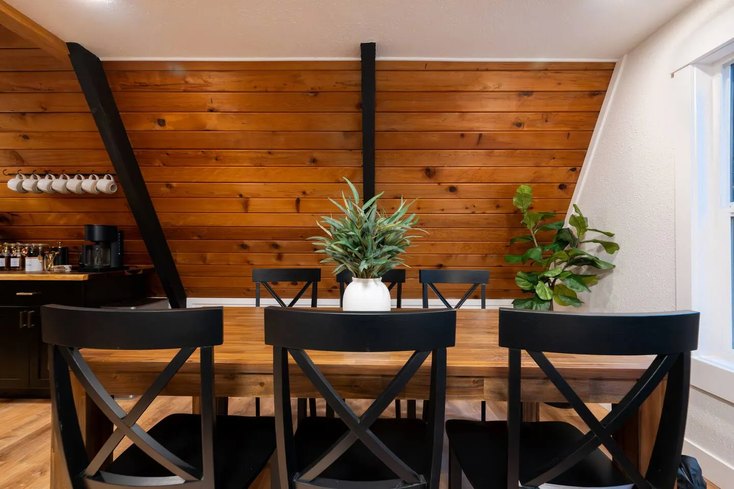 Dining table with wood-paneled A-frame walls