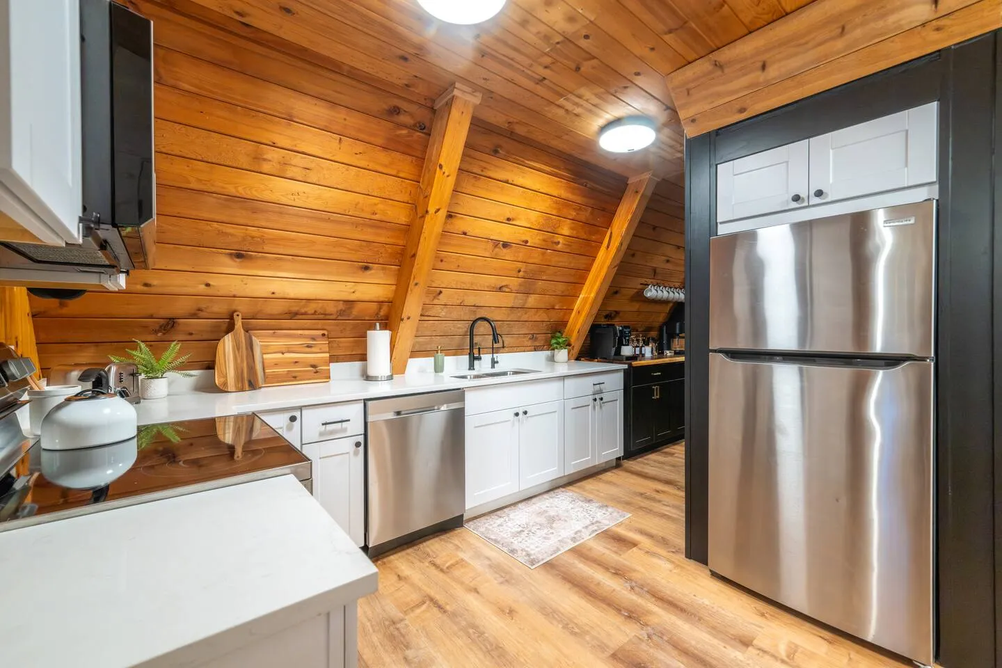 Chef’s kitchen with white cabinets and stainless appliances