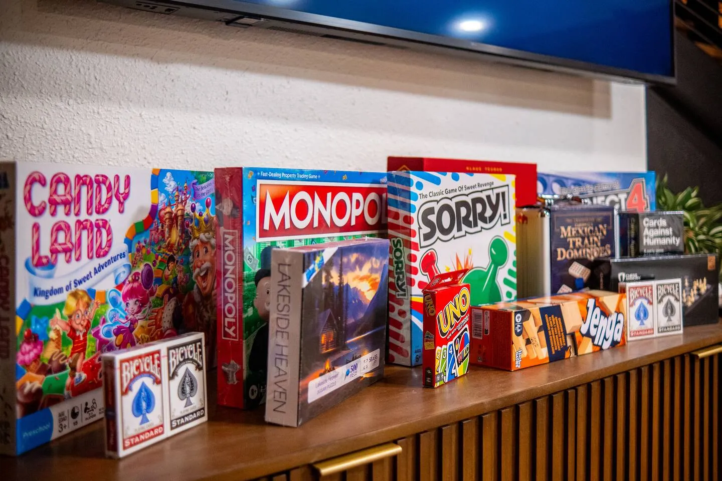 Shelf of board games including Monopoly and Candy Land
