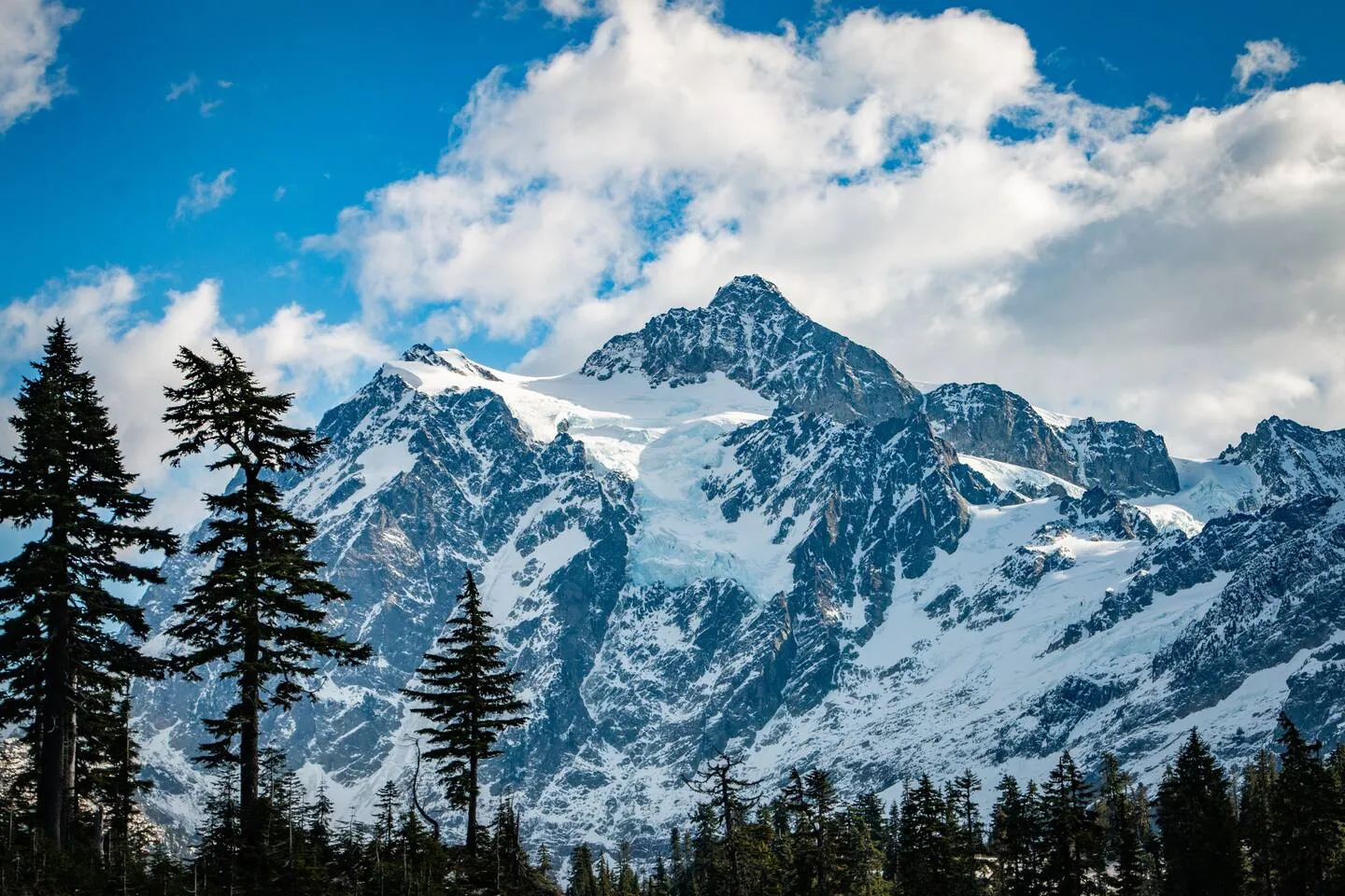 Mount Shuksan with snow against a blue sky