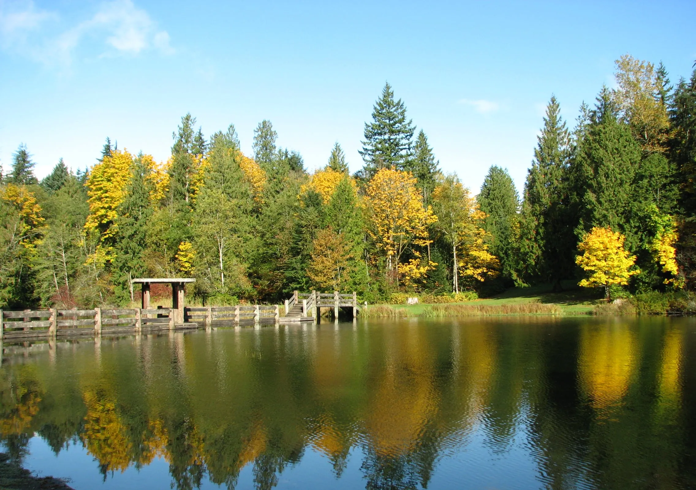The boat launch dock at Silver Lake Park with autumn colour reflected in the lake