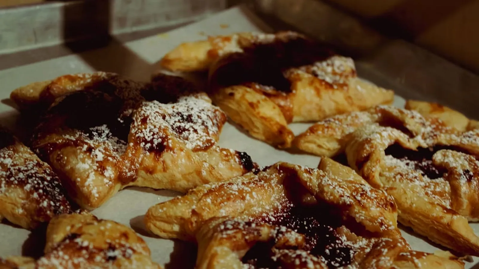 Fresh fruit pastries dusted with powdered sugar at Wake ’N Bakery