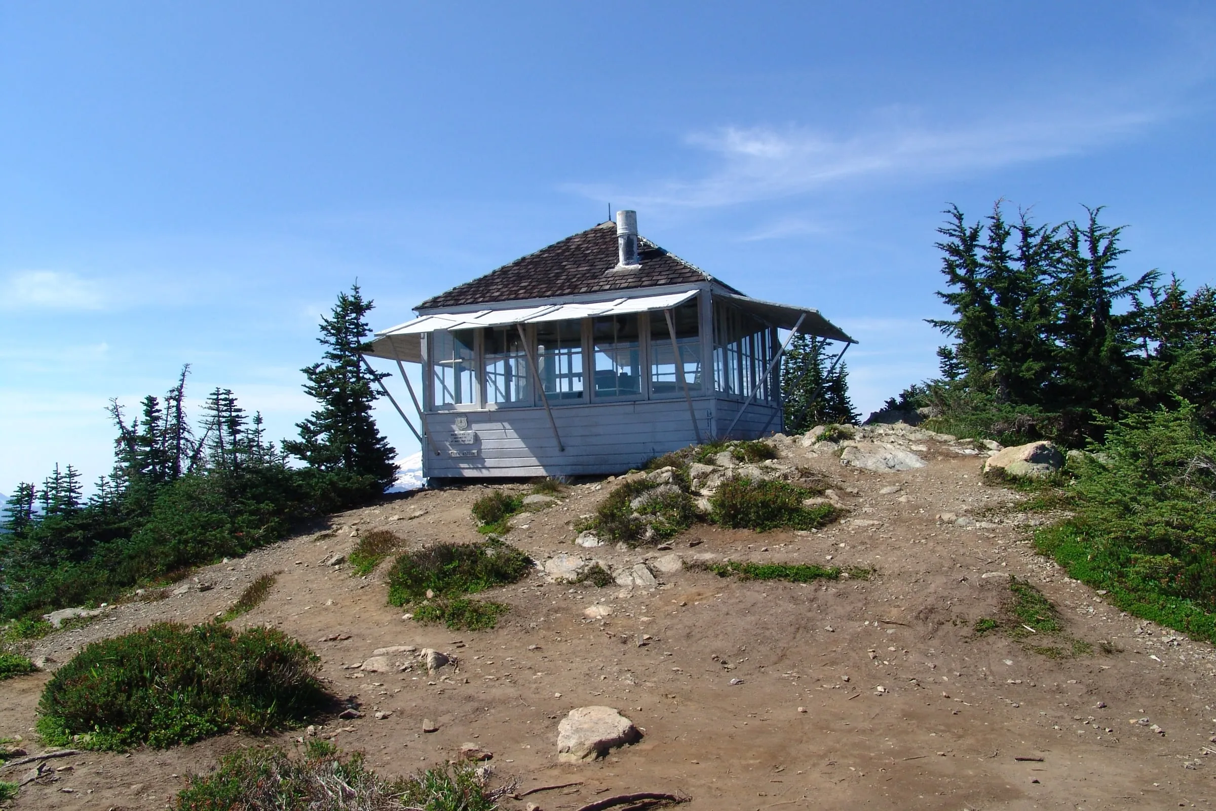 Winchester Mountain fire lookout on its rocky summit above Twin Lakes near Mt. Baker in summer